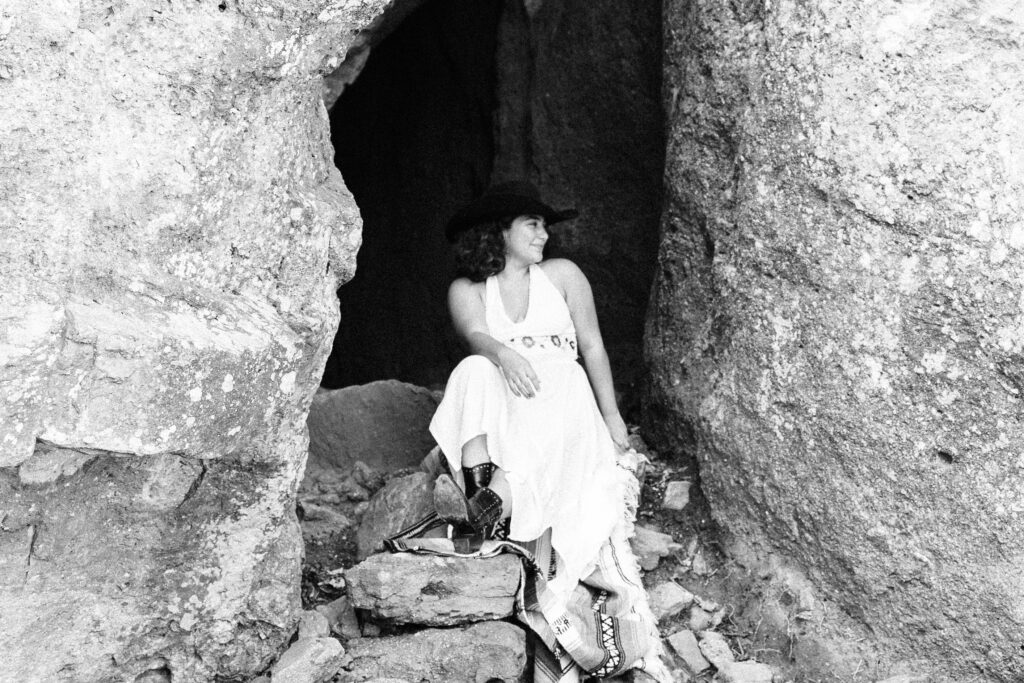 Colorado Elopement Photographer Sits on a Rock